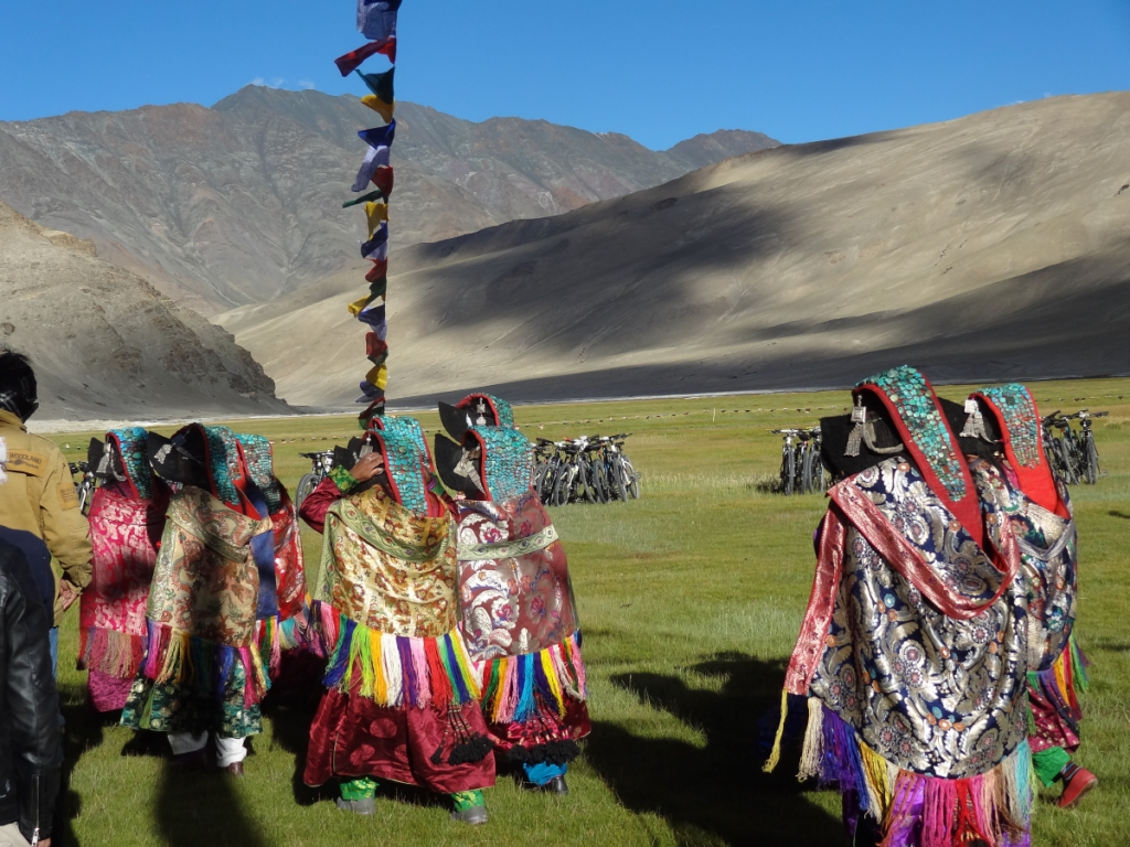 Ladakhi women wearing headdresses adorned with turquoise at a Buddhist festival.